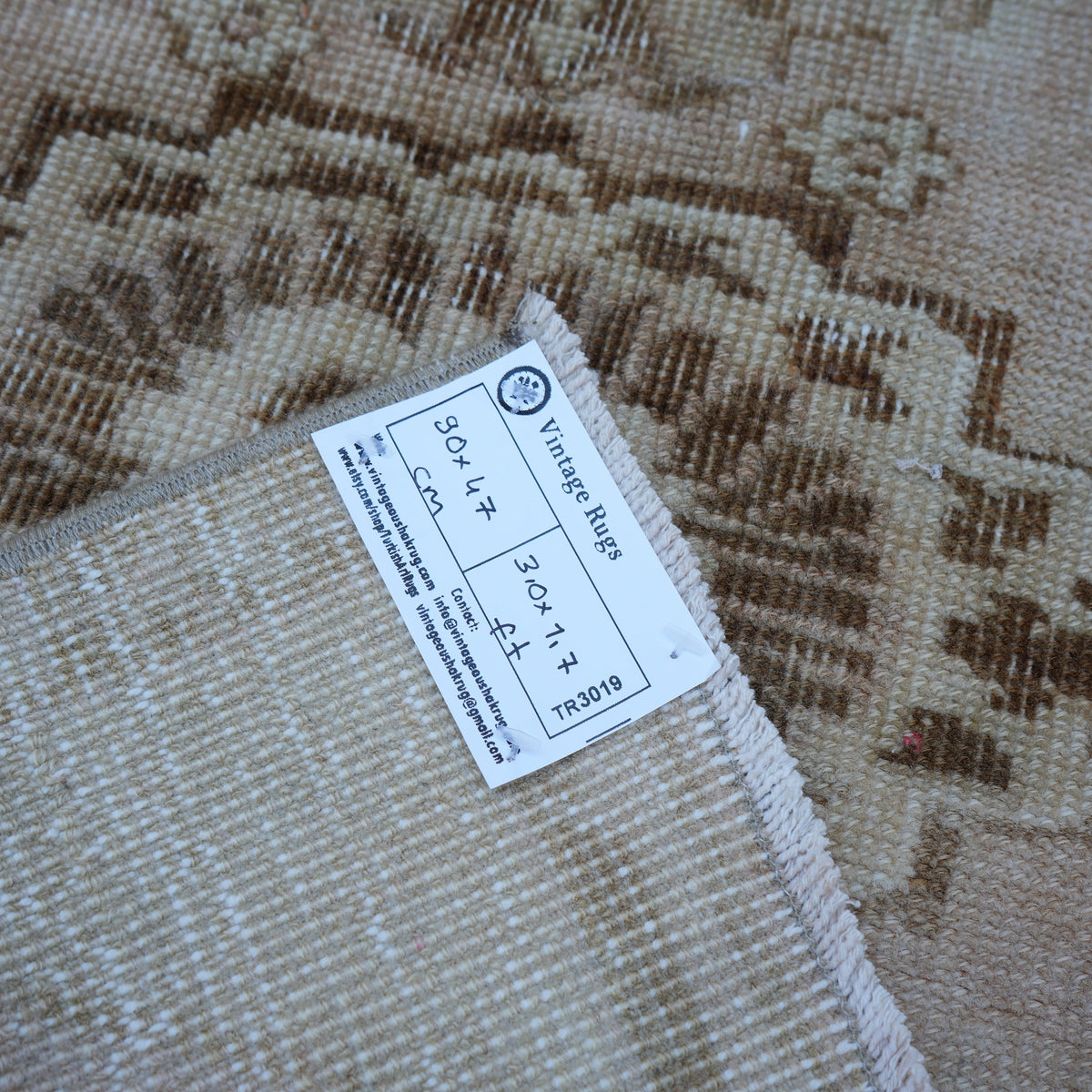 Beige 2' x 3' vintage turkish rug from the 1970s with neutral design.