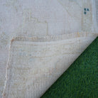 1970s beige vintage turkish rug with neutral design, hand-knotted weave and low pile.