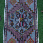Close-up of the blue vintage turkish rug showing traditional details, hand-knotted weave, wool and cotton and low pile.