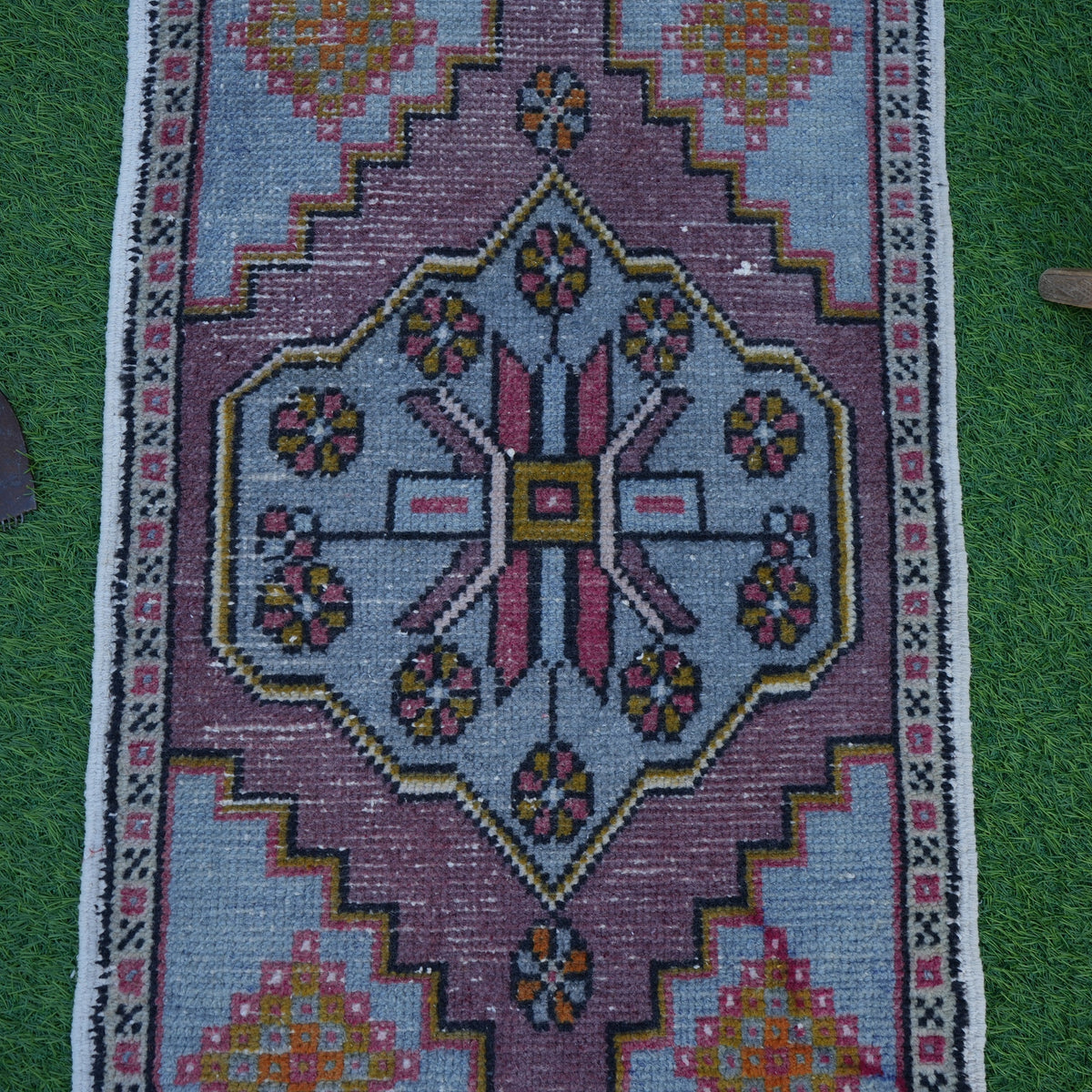 Close-up of the blue vintage turkish rug showing traditional details, hand-knotted weave, wool and cotton and low pile.