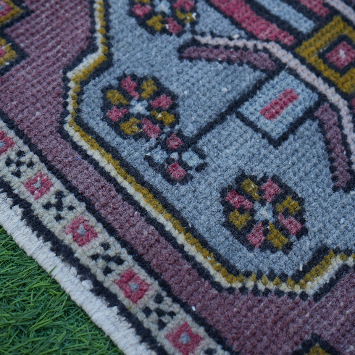 Blue 2' x 3' vintage turkish rug in wool and cotton, shown on the floor.