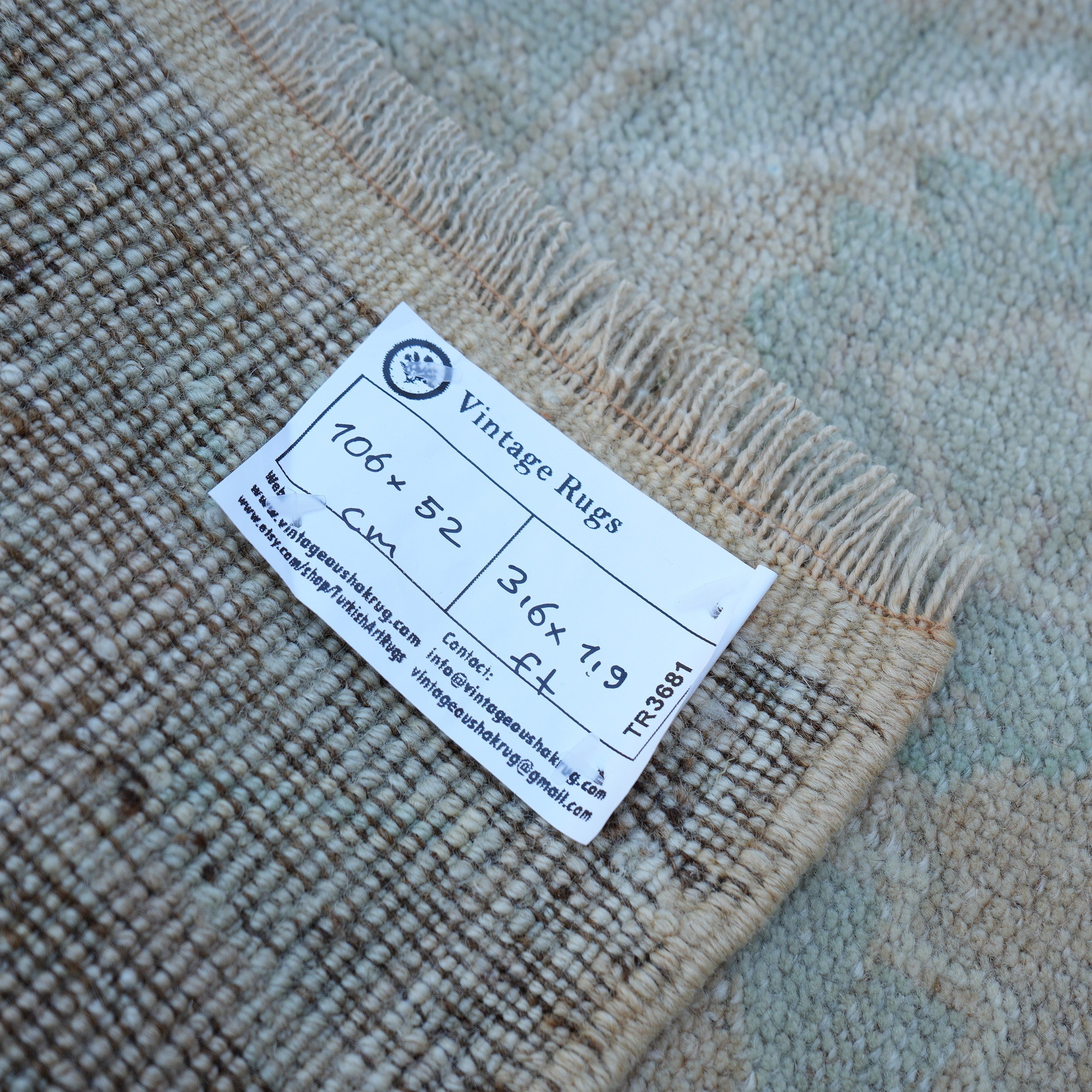 Brown 2' x 3' vintage turkish rug from the 1970s with neutral design.