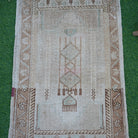 Close-up of the brown vintage turkish rug showing neutral details, hand-knotted weave, wool and cotton and low pile.