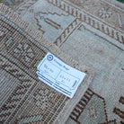 Brown 2' x 3' vintage turkish rug from the 1970s with neutral design.