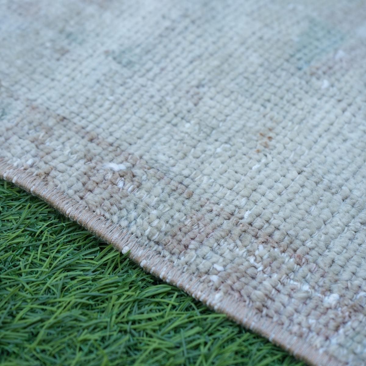 Brown 2' x 3' vintage turkish rug in wool and cotton, shown on the floor.