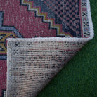 Pale Red 2' x 3' vintage turkish rug in wool and cotton, shown on the floor.
