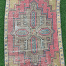 1970s pink vintage turkish rug with geometric design, hand-knotted weave and low pile.