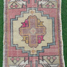1970s pink vintage turkish rug with geometric design, hand-knotted weave and low pile.