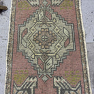 1970s pink vintage turkish rug with traditional design, hand-knotted weave and low pile.