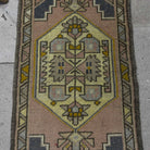 1970s pink vintage turkish rug with traditional design, hand-knotted weave and low pile.