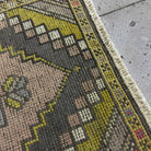 Close-up of the pink vintage turkish rug showing traditional details, hand-knotted weave, wool and cotton and low pile.