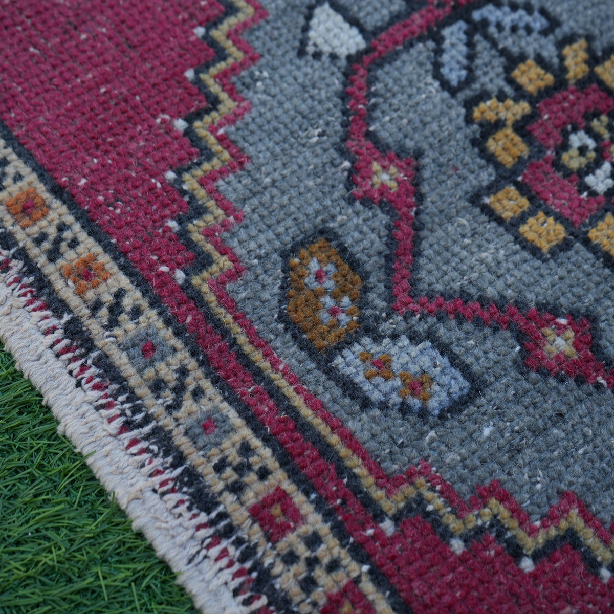 Red 2' x 3' vintage turkish rug in wool and cotton, shown on the floor.