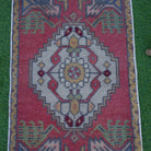 Close-up of the red vintage turkish rug showing traditional details, hand-knotted weave, wool and cotton and low pile.