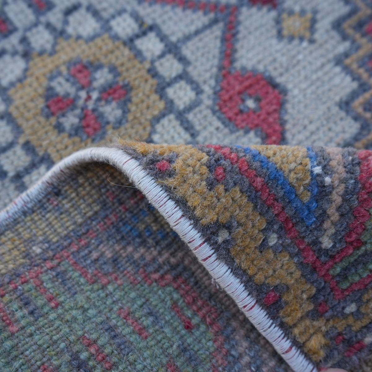 Additional view of the red vintage turkish rug, hand-knotted in wool and cotton.