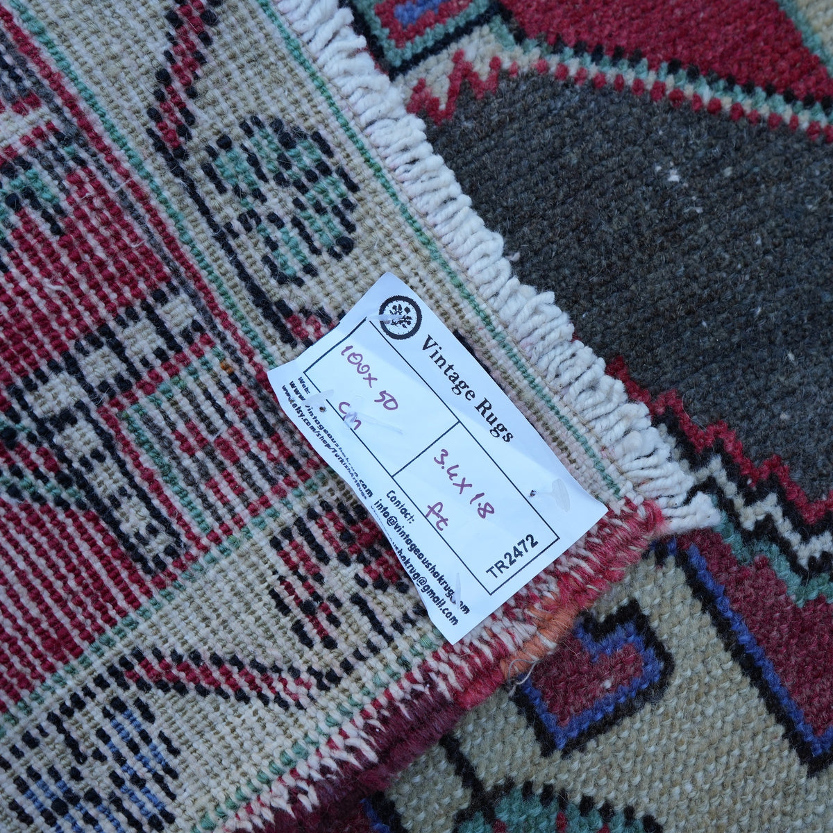 Red 2' x 3' vintage turkish rug from the 1970s with traditional design.