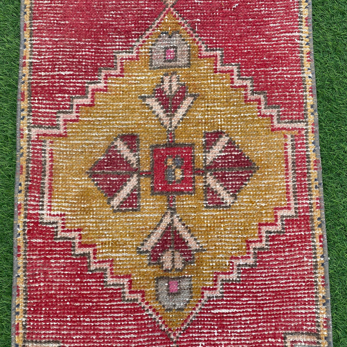 1970s red vintage turkish rug with traditional design, hand-knotted weave and low pile.