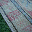 Red 2' x 3' vintage turkish rug in wool and cotton, shown on the floor.