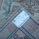 Red 2' x 3' vintage turkish rug from the 1970s with traditional design.