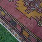 Red 2' x 3' vintage turkish rug in wool and cotton, shown on the floor.