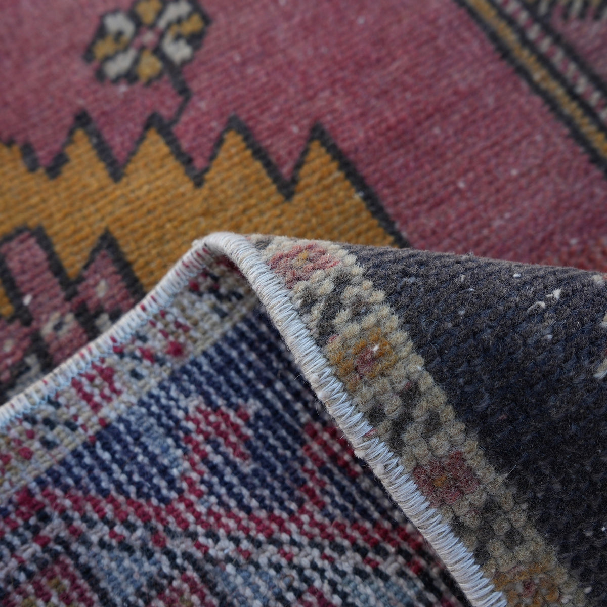 Additional view of the red vintage turkish rug, hand-knotted in wool and cotton.