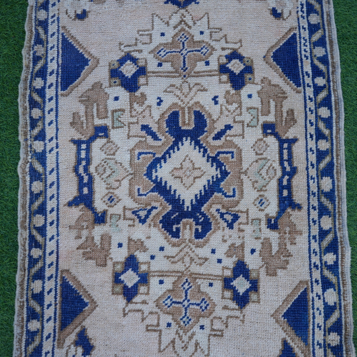Close-up of the blue vintage turkish rug showing traditional details, hand-knotted weave, wool and low pile.