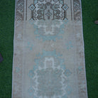 Close-up of the brown vintage turkish rug showing traditional details, hand-knotted weave, wool and cotton and low pile.