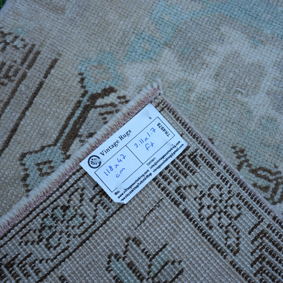 Brown 2' x 4' vintage turkish rug from the 1970s with traditional design.