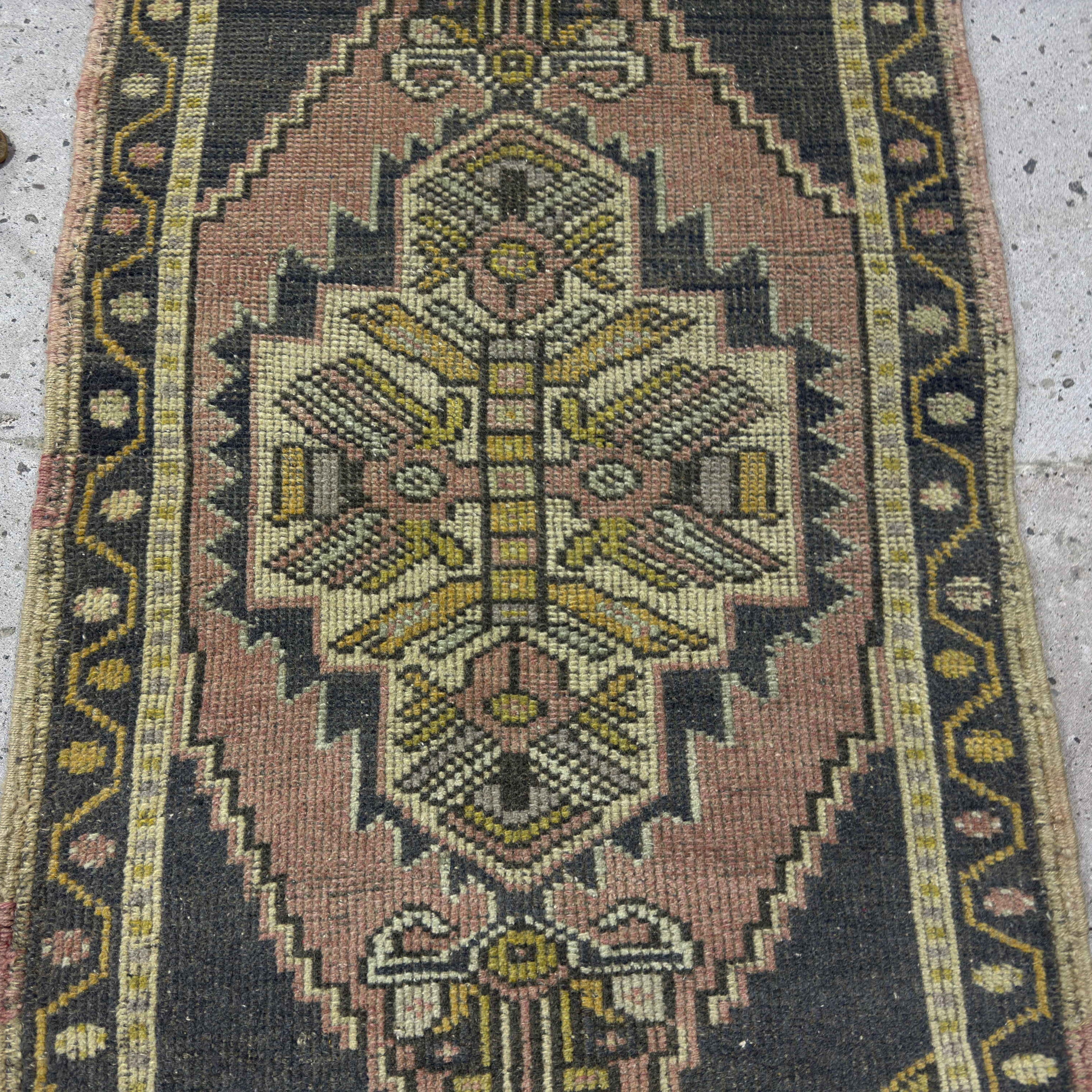 1970s pink vintage turkish rug with traditional design, hand-knotted weave and low pile.