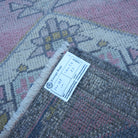 Pink 2' x 4' vintage turkish rug from the 1970s with traditional design.