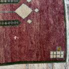 Close-up of the red vintage turkish rug showing traditional details, hand-knotted weave, wool and cotton and low pile.