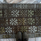 1970s brown vintage turkish rug with patchwork design, hand-knotted weave and low pile.