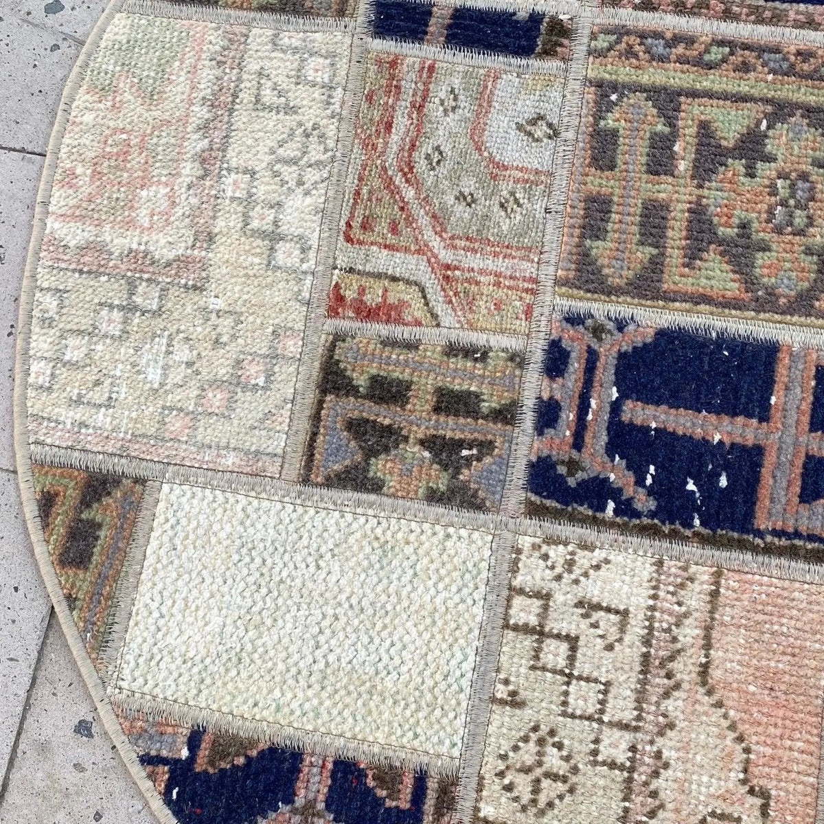 1970s blue vintage turkish rug with patchwork design, hand-knotted weave and low pile.