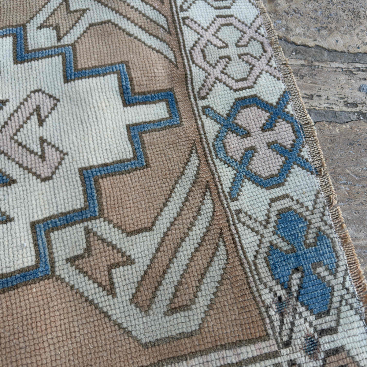 Close-up of the blue vintage turkish rug showing traditional details, hand-knotted weave, wool and cotton and low pile.