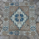 Blue 3' x 3' vintage turkish rug in wool and cotton, shown on the floor.
