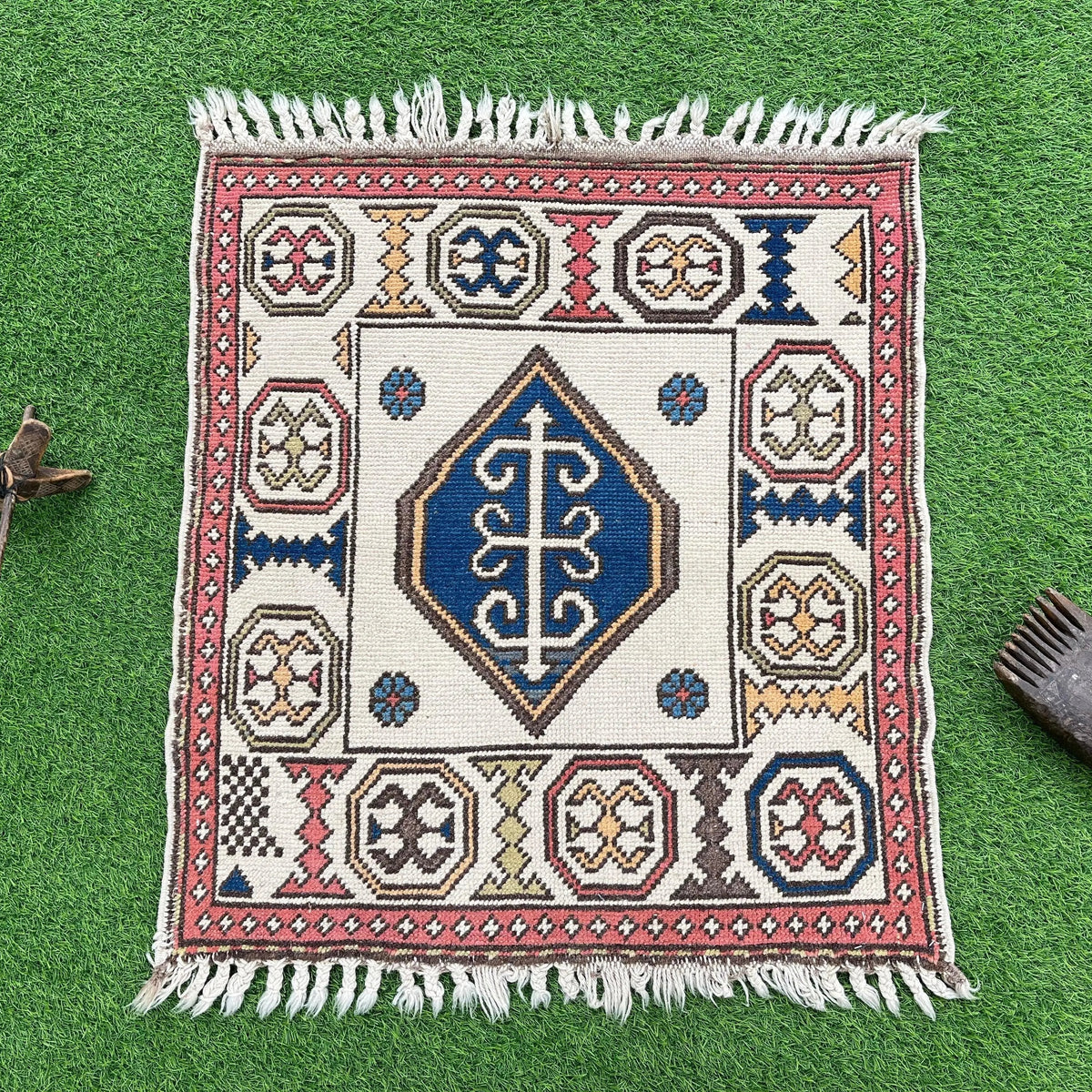 Red 3' x 3' vintage turkish rug in wool and cotton, shown on the floor.