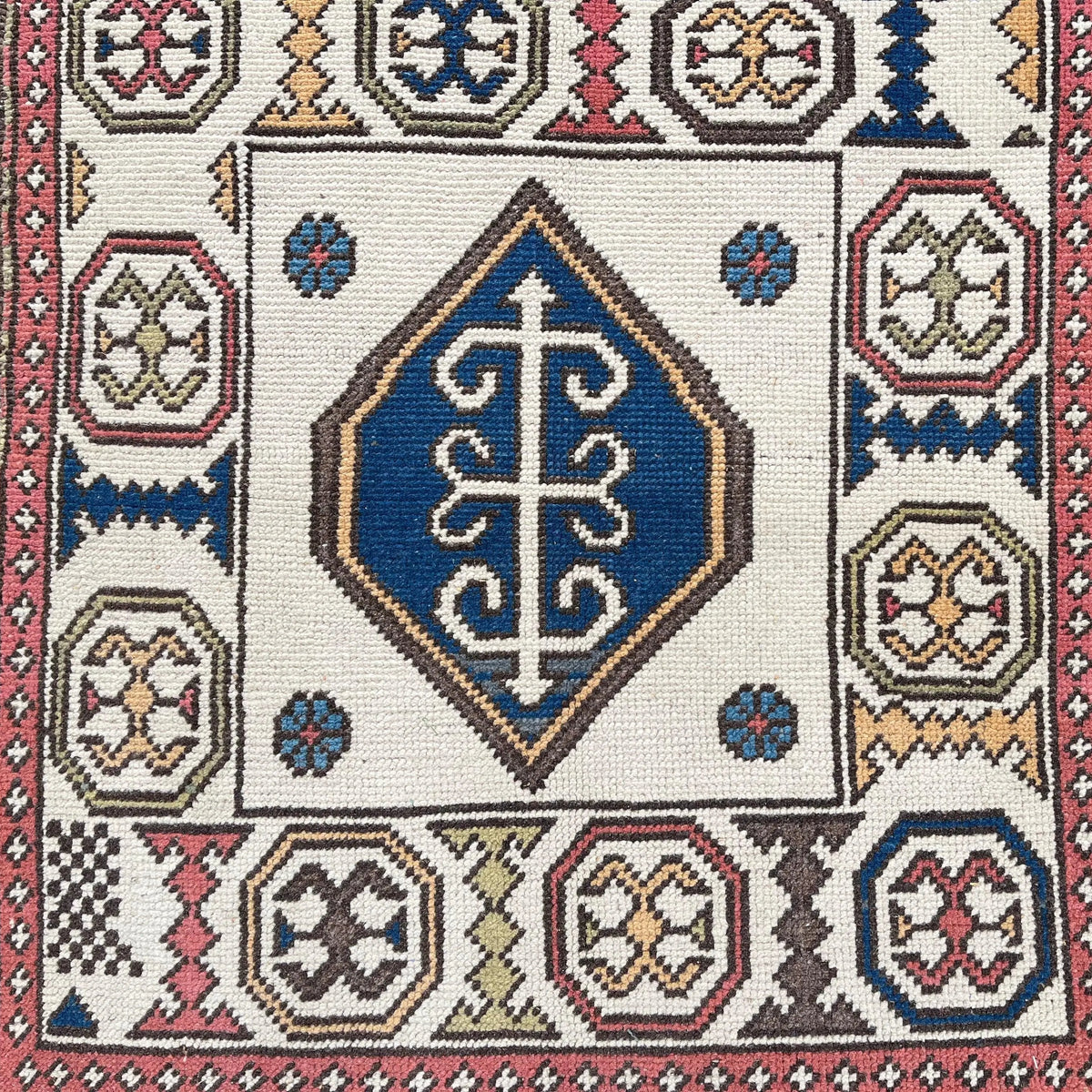 1970s red vintage turkish rug with geometric design, hand-knotted weave and low pile.