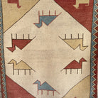 Red 3' x 4' vintage turkish rug in wool and cotton, shown on the floor.