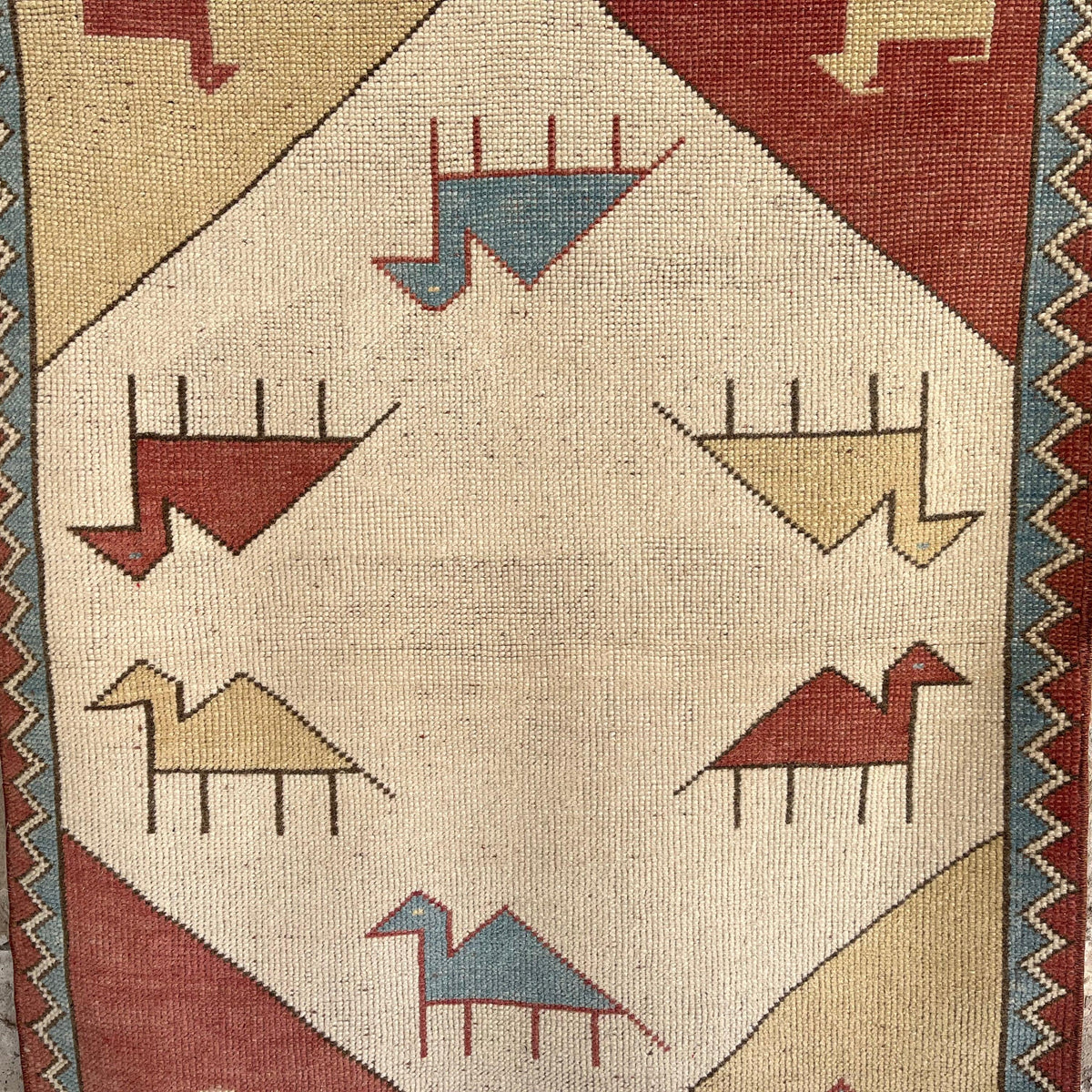 Red 3' x 4' vintage turkish rug in wool and cotton, shown on the floor.