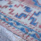 Blue 3' x 5' vintage turkish rug in wool, shown on the floor.
