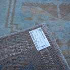 Blue 3' x 5' vintage turkish rug from the 1970s with neutral design.