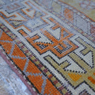 Orange 3' x 5' vintage turkish rug in wool and cotton, shown on the floor.