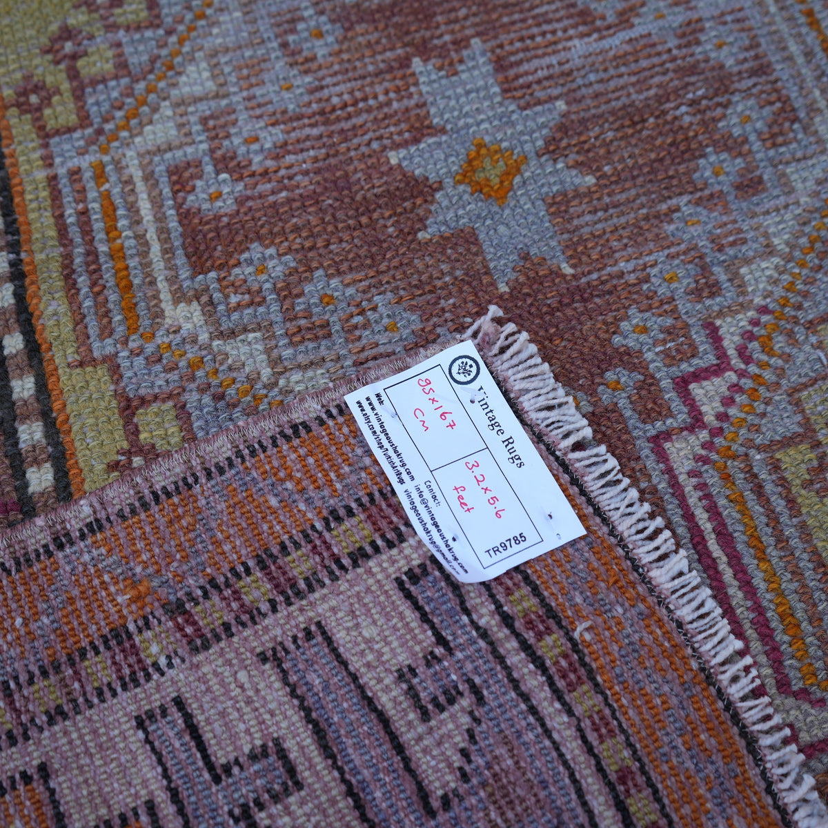 Orange 3' x 5' vintage turkish rug from the 1970s with traditional design.