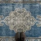 1970s blue vintage turkish rug with geometric design, hand-knotted weave and low pile.
