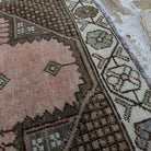 Close-up of the pink vintage turkish rug showing traditional details, hand-knotted weave, wool and cotton and low pile.