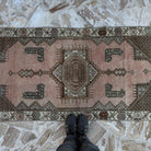 1970s pink vintage turkish rug with traditional design, hand-knotted weave and low pile.
