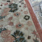 Close-up of the red vintage turkish rug showing floral details, hand-knotted weave, wool and cotton and low pile.