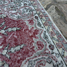 Close-up of the red vintage turkish rug showing traditional details, hand-knotted weave, wool and cotton and low pile.