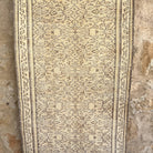 Beige 3' x 7' vintage turkish rug in wool and cotton, shown on the floor.