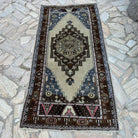 Blue 3' x 7' vintage turkish rug in wool and cotton, shown on the floor.