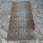 Pale Orange 3' x 7' vintage turkish rug in wool and cotton, shown on the floor.
